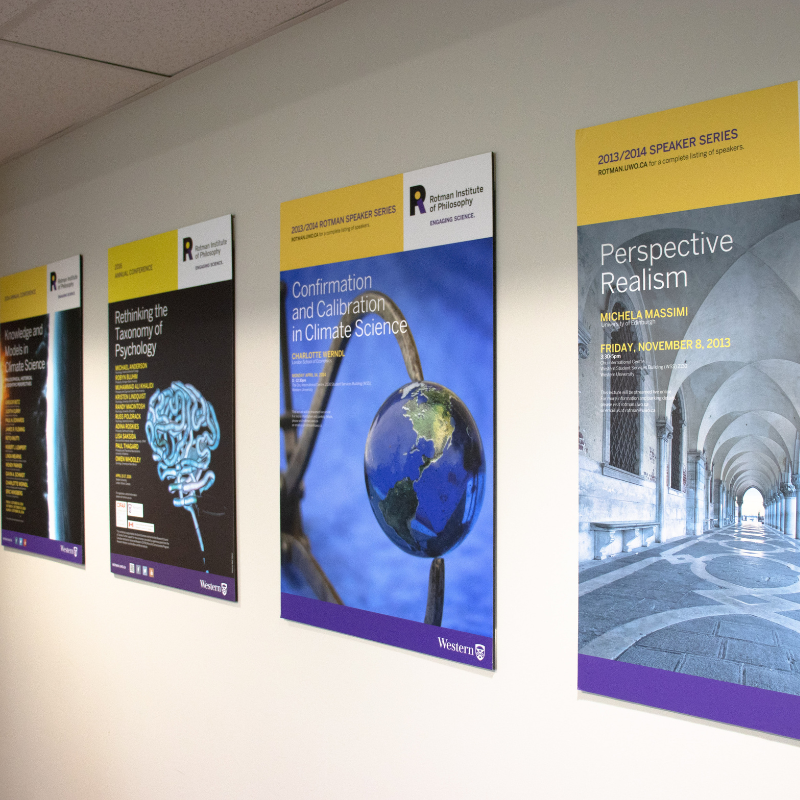 Previous Rotman event posters are displayed on the wall along the hallway